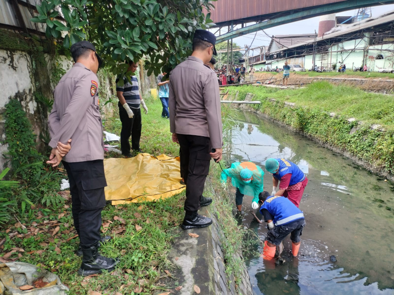 Tim Kepolisian mengevakuasi mayat tanpa identitas di kanal sungai PG Candi
